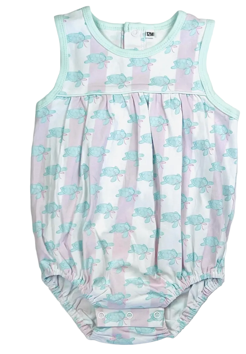A sleeveless baby romper with a white base, light pink vertical stripes, and a repeating light blue sea turtle pattern. It features mint green trim and elasticated leg cuffs.